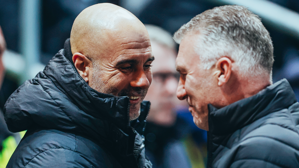 BOSSES : Guardiola and Pearson share a warm embrace ahead of kick-off.