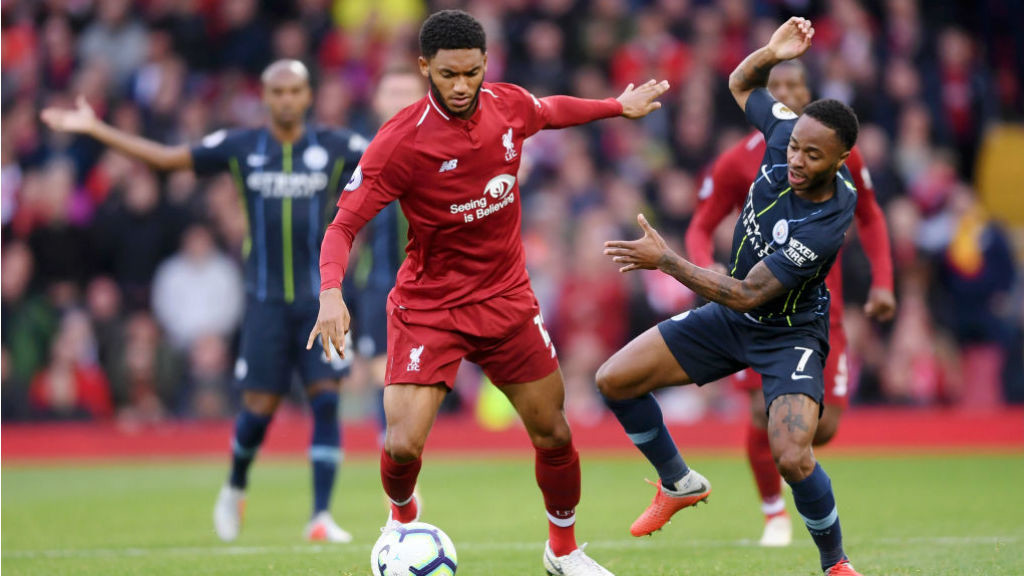 AT ARM'S LENGTH : Raheem Sterling looks to challenge Joe Gomez