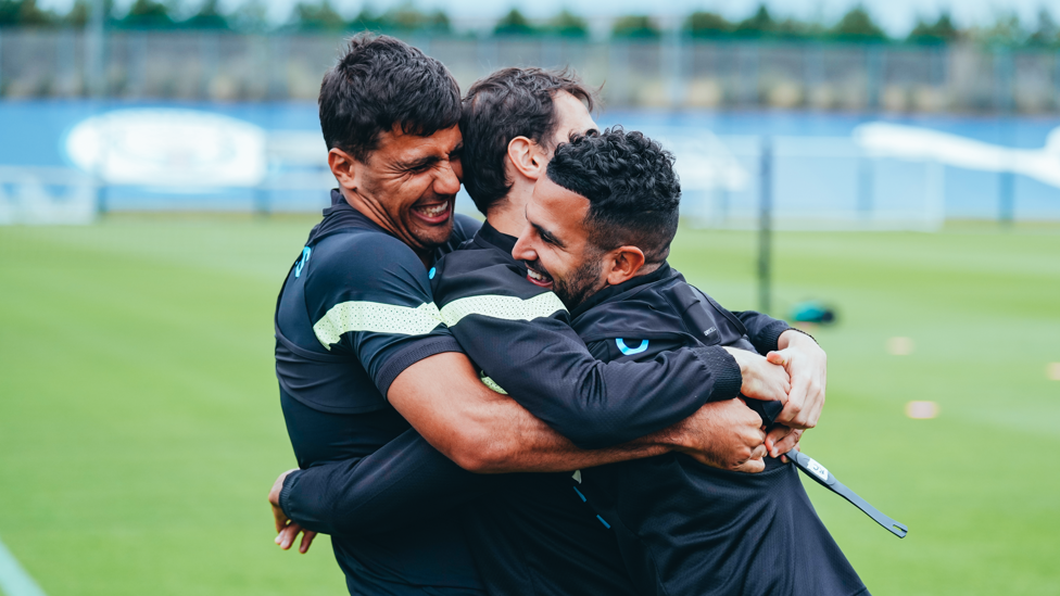 SILVA SANDWICH : Bernardo Silva gets a hug from Rodrigo and Riyad Mahrez