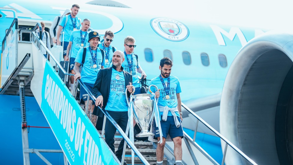 WELCOME BACK : The Treble winners arrive in Manchester after our UEFA Champions League triumph