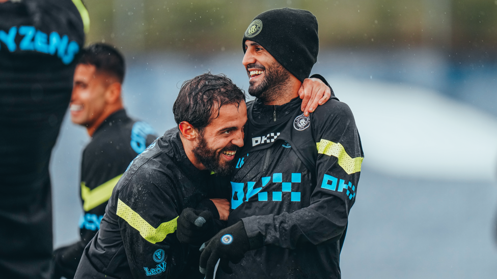 LAUGH INN: Bernardo and Riyad Mahrez smile through the showers