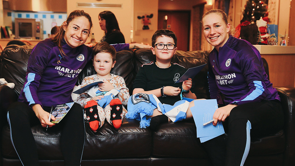 RELAXATION TIME : Janine Beckie and Pauline Bremer chill out on the sofa with two of the children