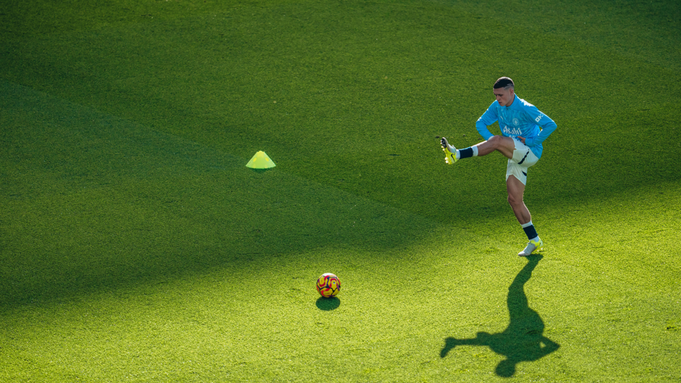 PHIL-ING GOOD : Foden gets in the mood during the pre-match warm up.