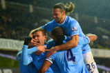 Edin Dzeko celebrates scoring against Spurs.