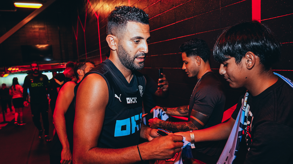 Riyad stops to sign items in the Golden Circle