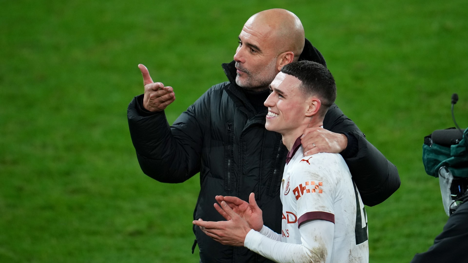 ALL SMILES: Pep celebrates with Phil Foden at full time