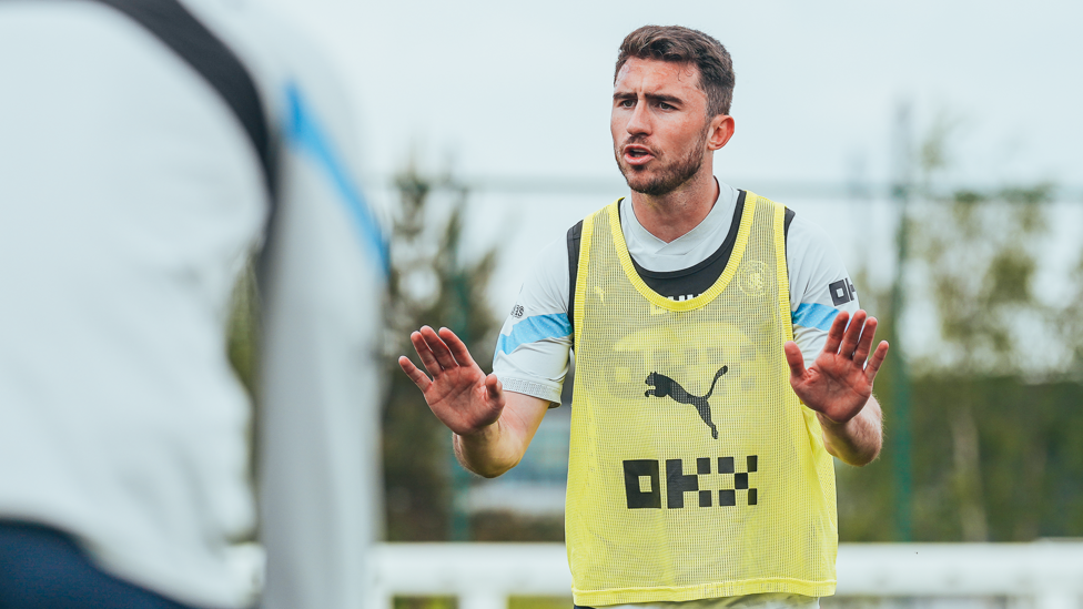 LOGICAL LAPORTE : Aymeric Laporte offers words of wisdom during training.