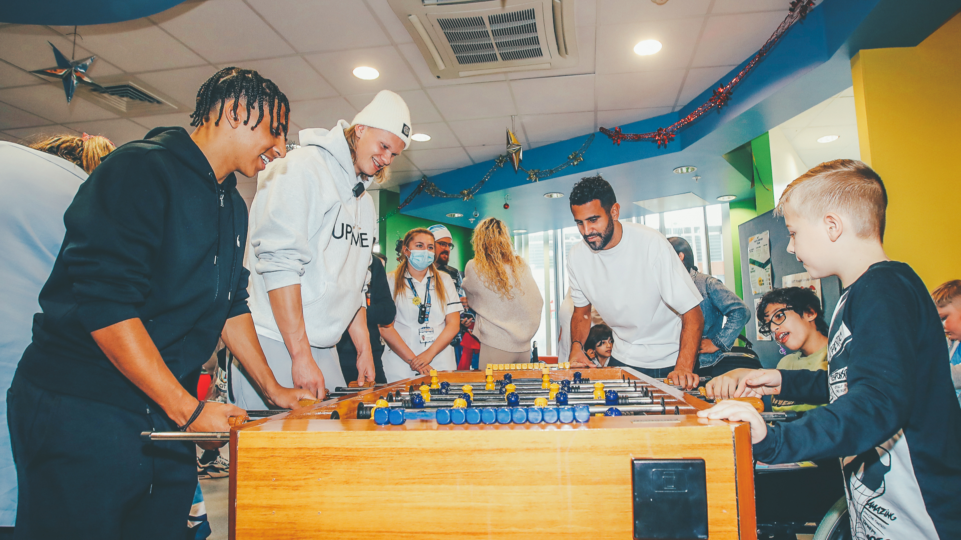 FESTIVE FUN : City's first team stars bring Christmas cheer to Royal Manchester Children’s Hospital.