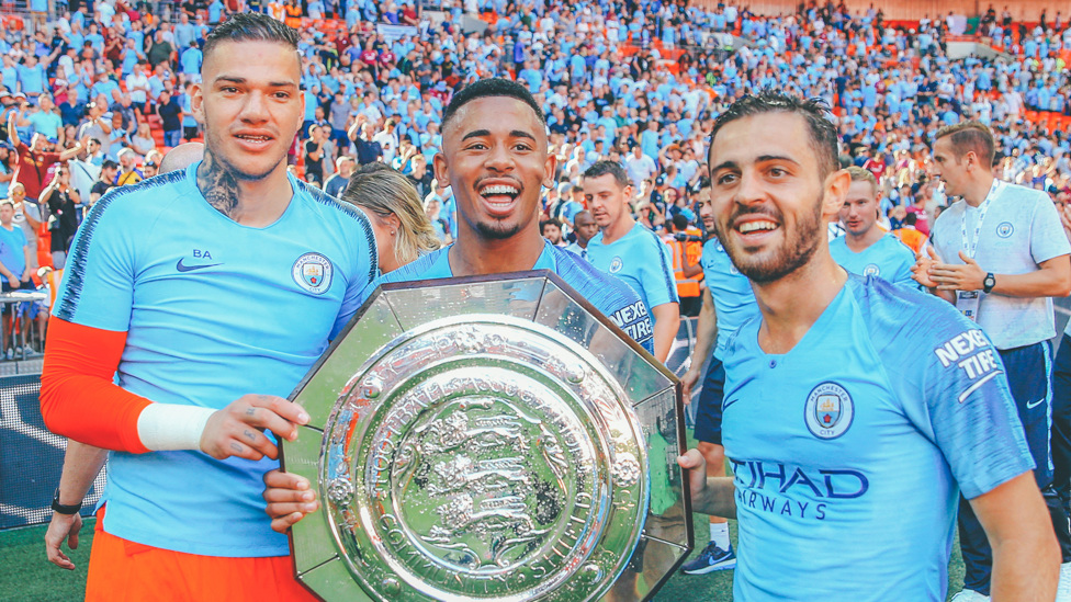 STRONG START : The Brazilian celebrates winning the Community Shield with Ederson and Bernardo Silva, 5 August 2018.