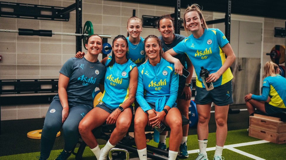 ALL SMILES : Players pose with backroom staff in the gym