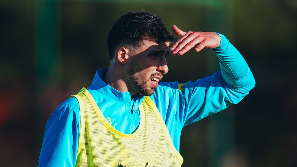 IN THE SHADE : Ruben Dias shields his eyes from the sun