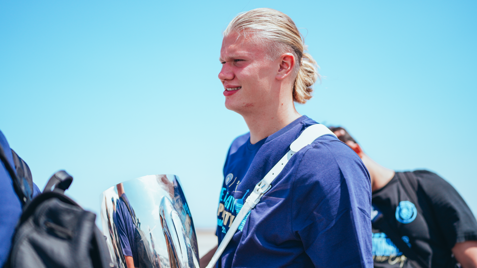 SILVERWARE : Erling Haaland boards the plane with the Super Cup