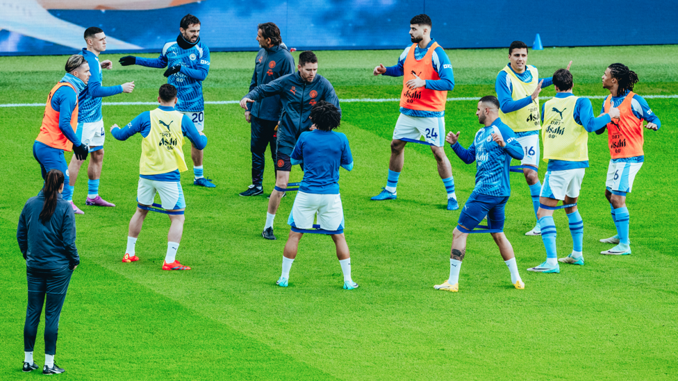 LOOSING UP: The team are taken through their pre-match stretches.