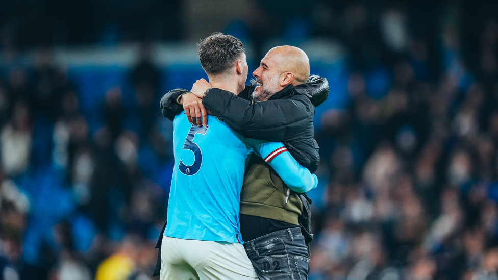 WHAT A WIN : The boss celebrates with Stones after full time.