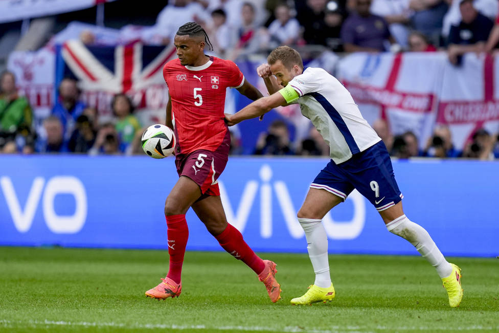 UNDER PRESSURE : Manuel Akanji being tested by England's Harry Kane.