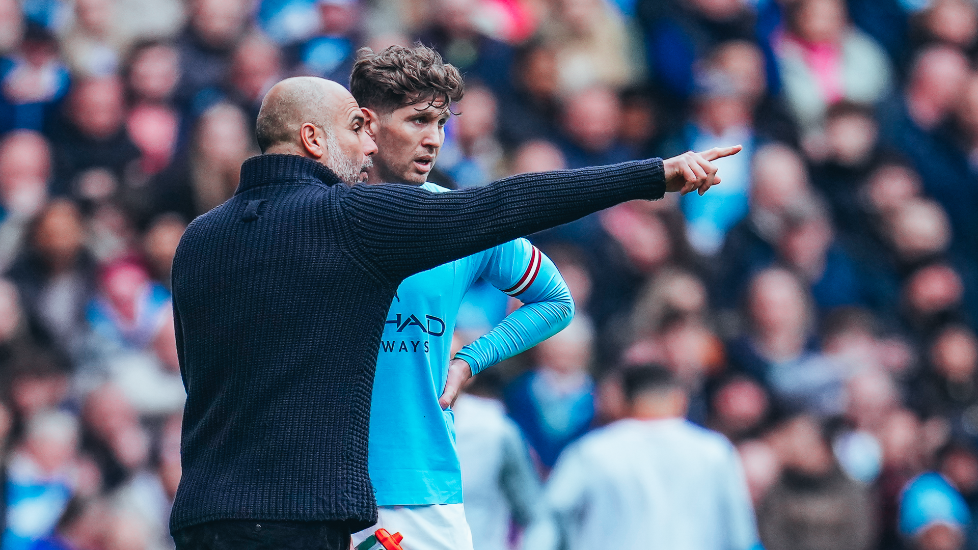 MIDFIELD THAT WAY : John Stones receives advice from Pep Guardiola