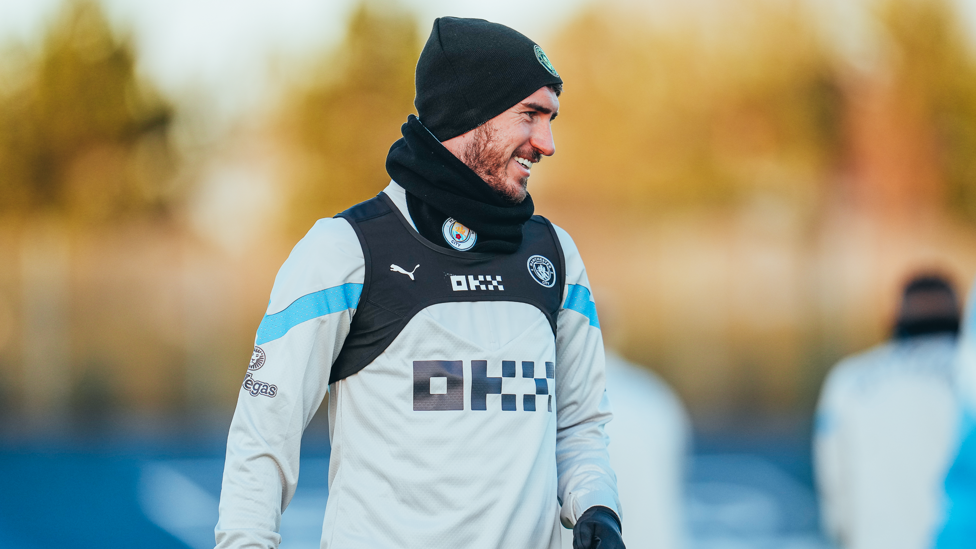 WARM WELCOME : Aymeric Laporte is beating the elements in his hat and snood