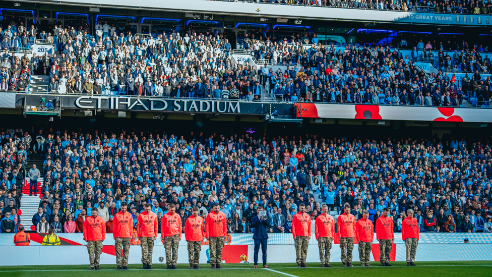 WE WILL REMEMBER THEM : The players and fans observe a period of silence to remember those who served and gave the ultimate sacrifice on our behalf. 