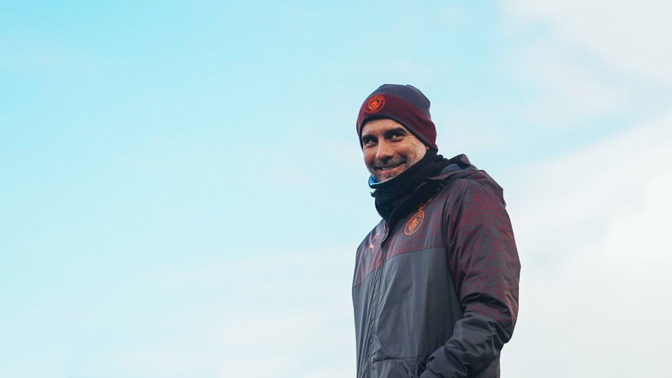 A CHEEKY GRIN : Pep Guardiola enjoying the chilly afternoon session. 