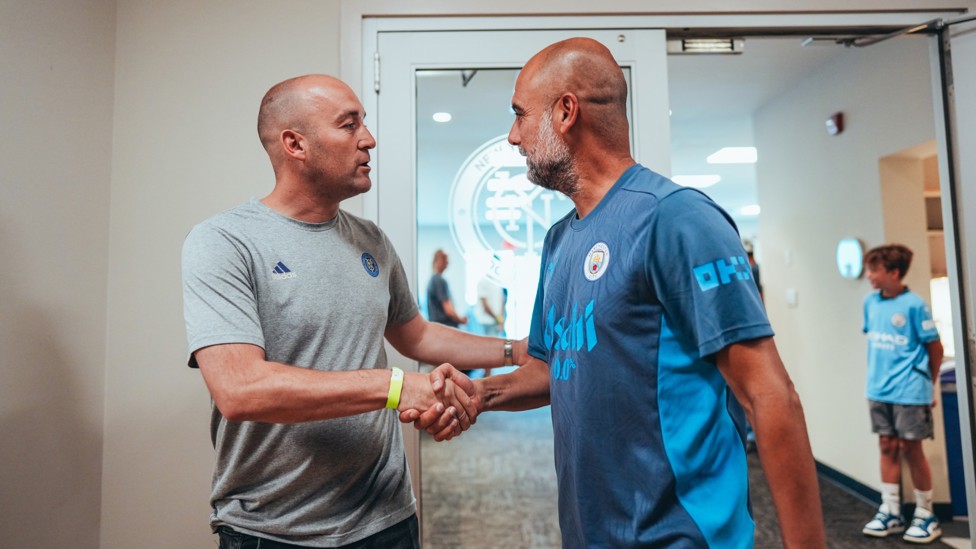 MEETING OF THE MINDS : Guardiola and New York City head coach Nick Cushing in conversation. 