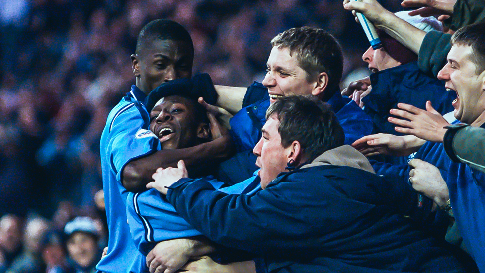 MOBBED : Shaun Wright-Phillips celebrates rounding off the scoring against Bradford with the City fans | 16 December 2001.