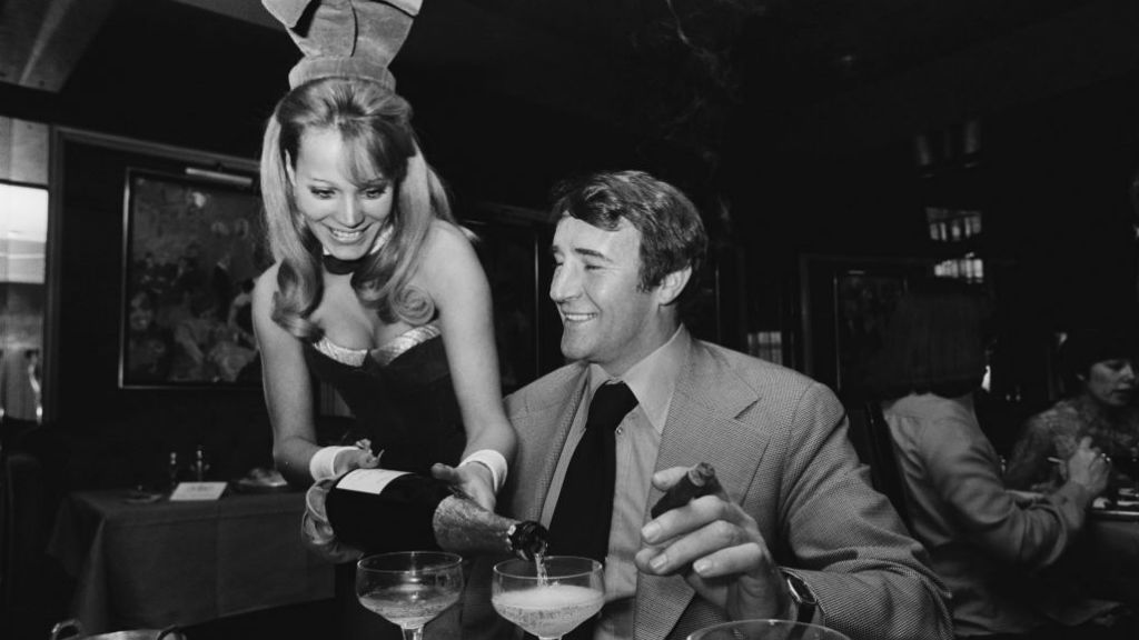 LARGER THAN LIFE: Big Mal relaxes with a trademark cigar, champagne and the company of a Bunny Girl!