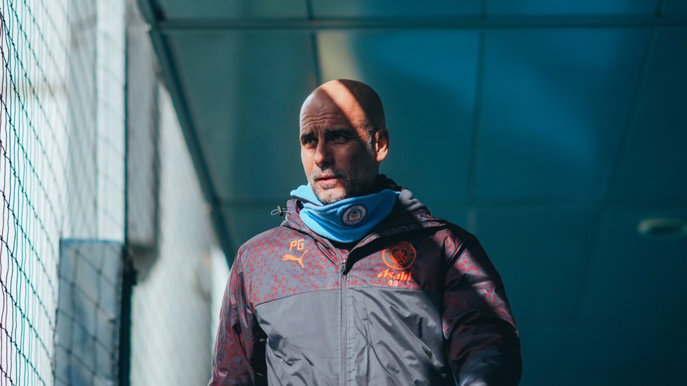 PREPARING  : Pep Guardiola walks onto the training field.