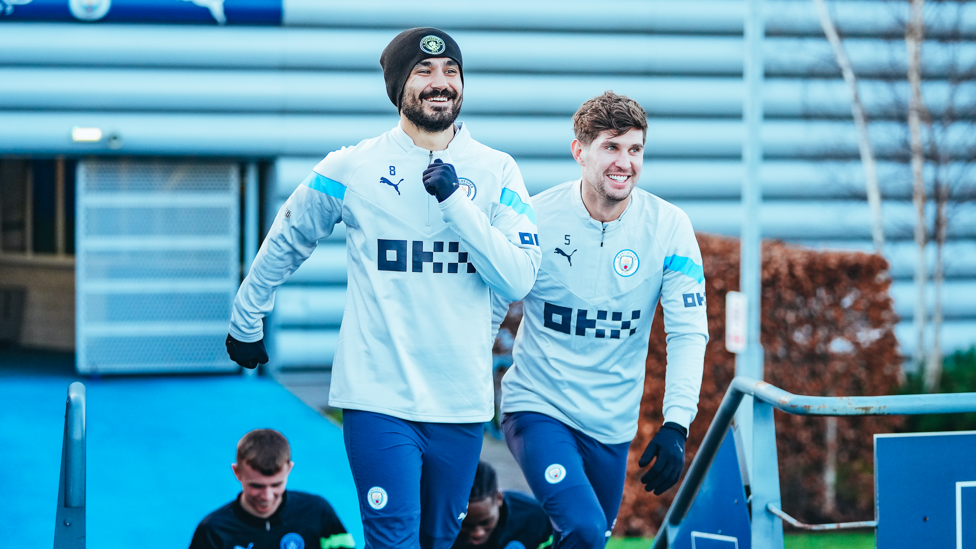 ALL SMILES : Ilkay Gundogan is happy to see John Stones back at the CFA