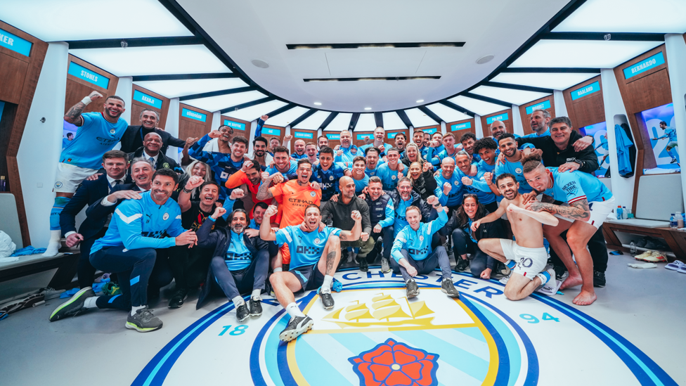 THIS TEAM! : The entire City team celebrate in the changing rooms. 