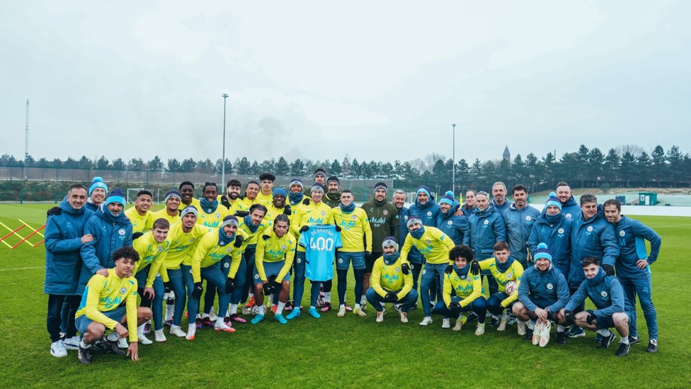 TOGETHER : The players and coaching staff pictured celebrating De Bruyne's latest achievement.