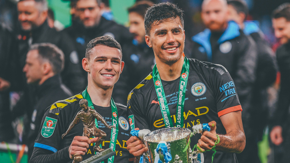 MIDFIELD MAGICIANS : He celebrates his second piece of City silverware - after the Community Shield - with Phil Foden