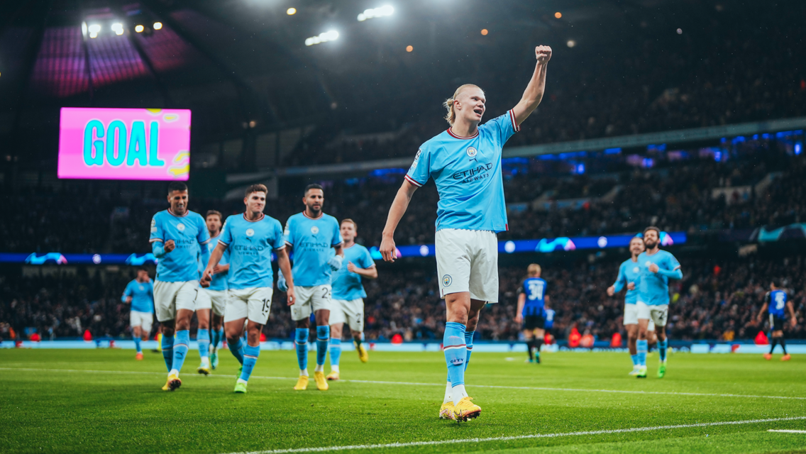 MAIN MAN: The players rush to celebrate with Haaland.