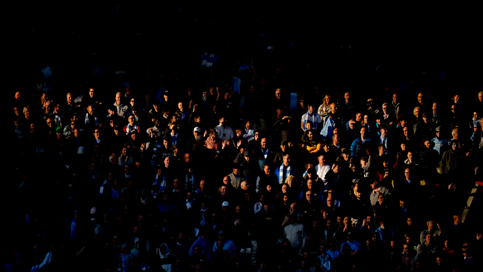 SUN AND SHADE : A lucky section of City supporters!