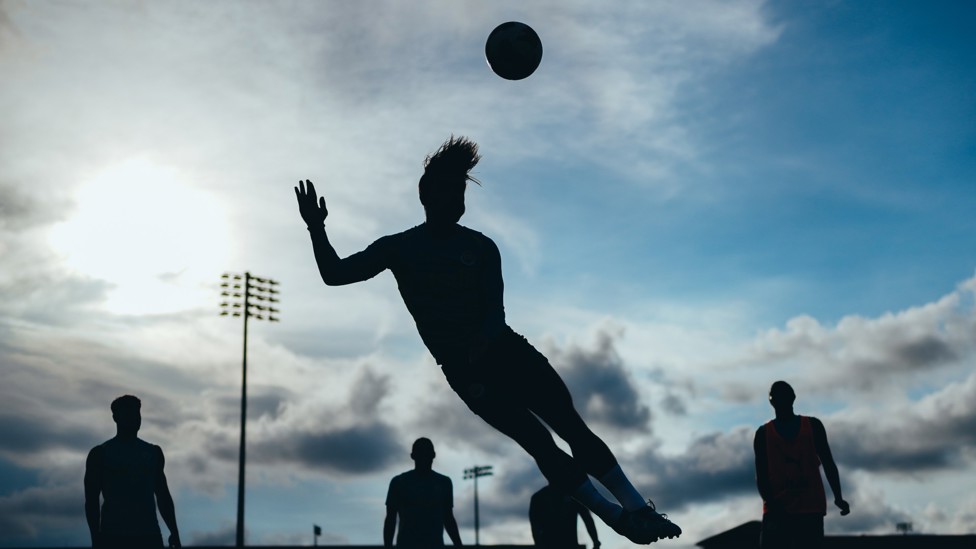 SILHOUETTE : Jack Grealish stretches for a header