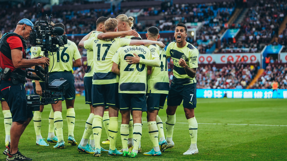 GROUP HUG : The players share the love after the opener.