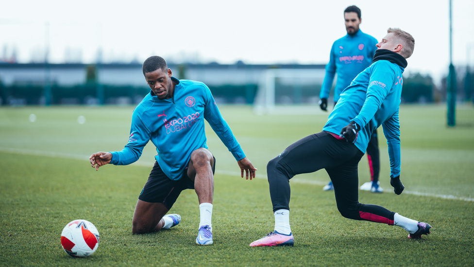 STRETCHING OUT : Luke Mbete and Oleksandr Zinchenko try to claim possession