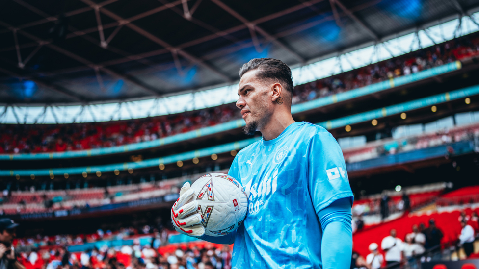 SAFE HANDS : Ederson gets a feel of the ball during the pre-match warm up.