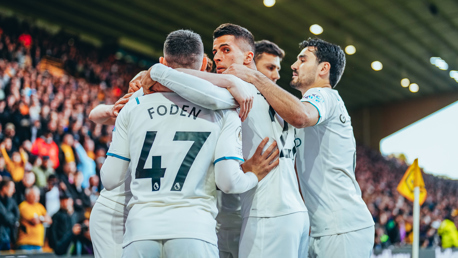 GROUP HUG: Feeling the love after the opening goal.