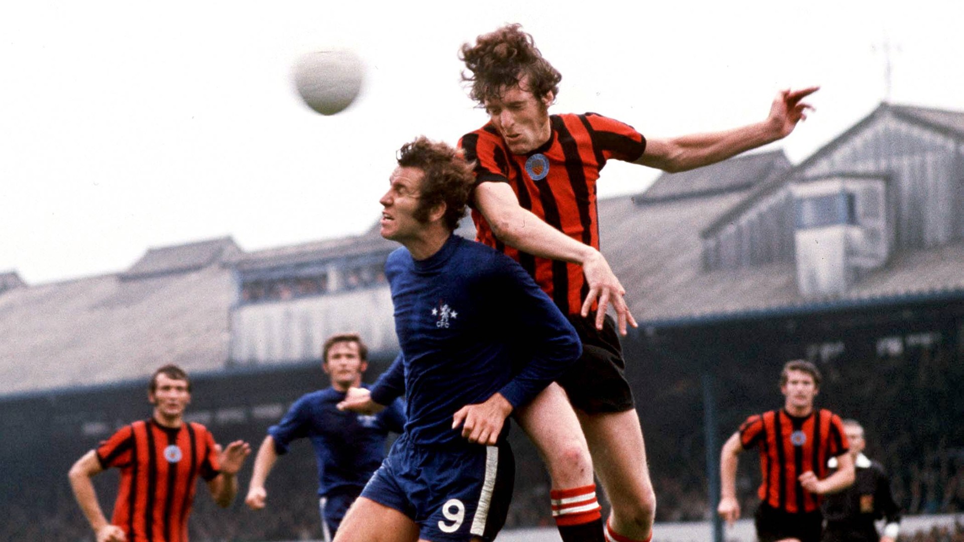 RISE AND SHINE: Tommy towers in the air to beat Chelsea's Peter Osgood in an early 1970s clash.