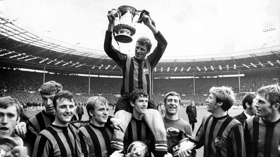 LIFT IT HIGH : Tony Book, surrounded by his teammates, holds up the famous FA Cup trophy after our 1969 victory at Wembley Stadium