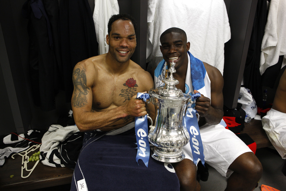 SILVERWARE : Joleon Lescott and Richards soak up all the celebrations and grab a picture with the FA Cup trophy