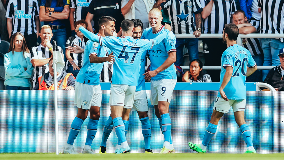 ALL SMILES : Gundogan is mobbed by his teammates after the early goal.