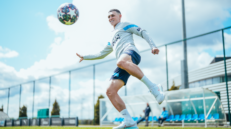 ALL SMILES : Phil Foden gets a feel for the Champions League ball