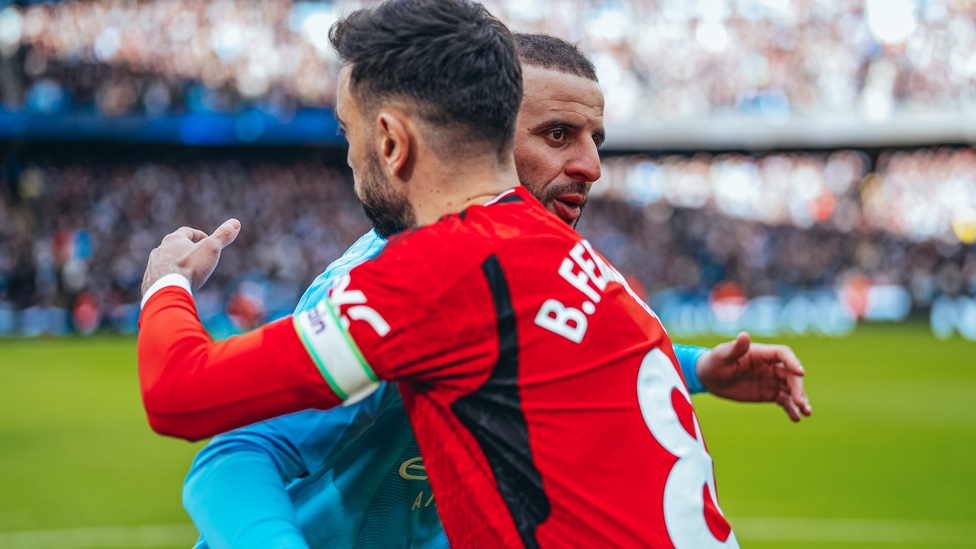 CALM BEFORE THE STORM : The captains embrace ahead of kick-off.