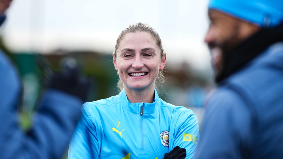 ALL SMILES : Laura Coombs in high spirits as training begins.