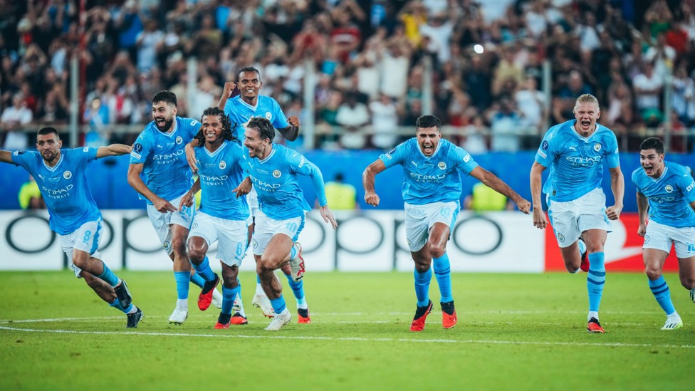 RACE IS ON : The players rush to Ederson after the penalties victory in the UEFA Super Cup