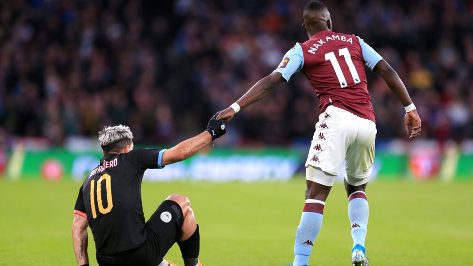 SPORTSMANSHIP : Nakamba helps Aguero up during a tense second half.