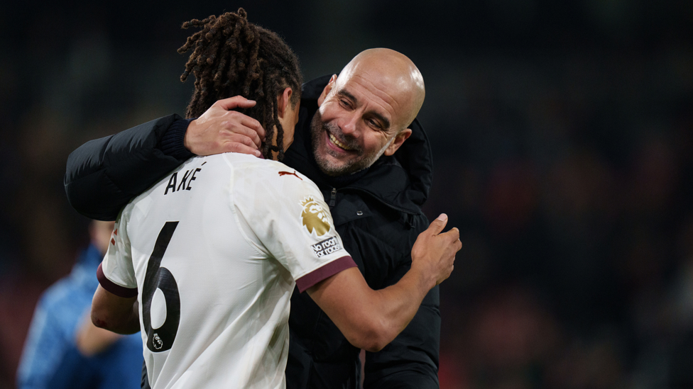 HAPPY WITH THAT : Pep Guardiola and Nathan Ake embrace with joy following City's latest win.