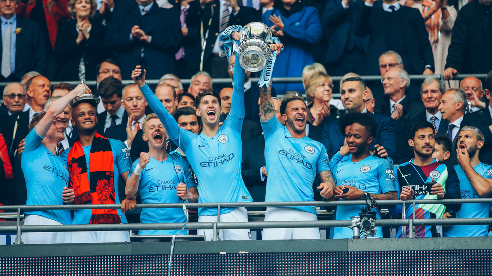 COMPLETING THE SET: John hoists the FA Cup aloft after beating Watford in May 2019.