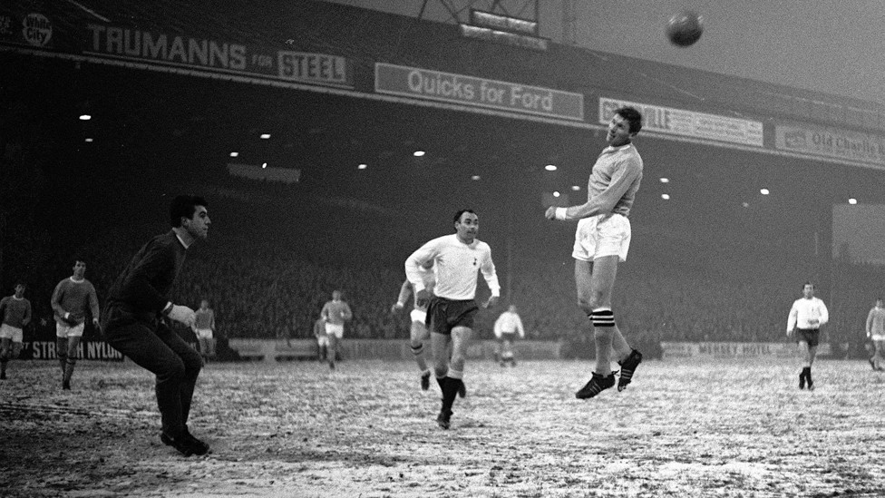 BALLET ON ICE : Tony Book heads clear from Tottenham’s Alan Gilzean in the famous 4-1 victory on a snowy Maine Road in 1967